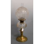A Victorian oil lamp, having etched globular glass shade above a clear glass font, on brass pedestal