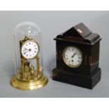 An Edwardian black slate and rouge marble cased mantel clock, having an enamelled dial with Roman