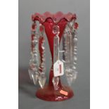 A Victorian cranberry glass lustre having frilled rim to slender neck and bulbous body with clear