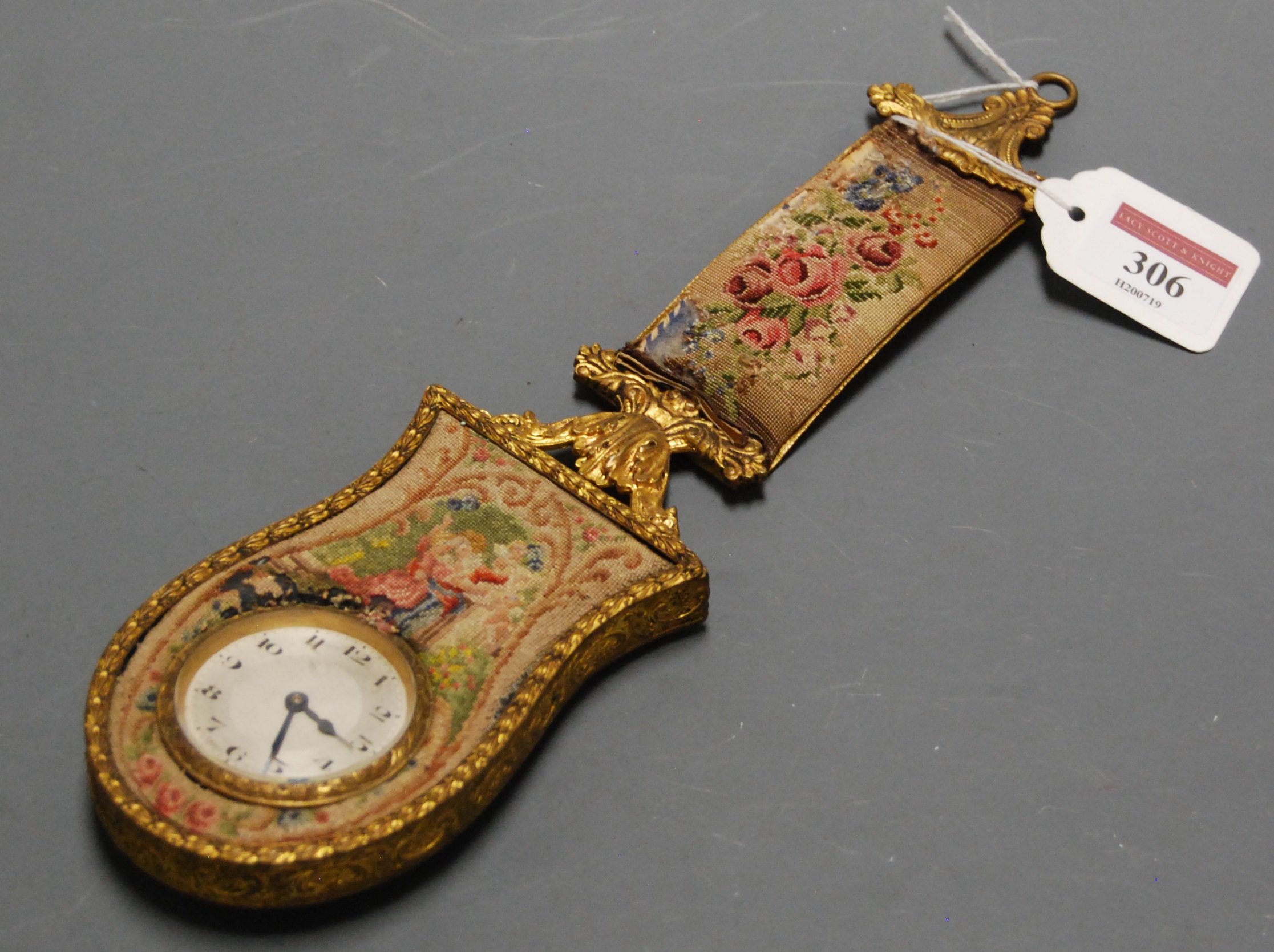 An early 20th century fob watch, having engine turned dial with Arabic numerals, housed in a gilt