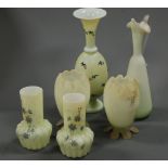 A pair of Victorian yellow tinted glass vases having tapering necks to fluted lower body with