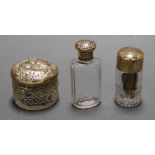 A circa 1900 cut glass dressing table jar with silver top and embossed with various putti together