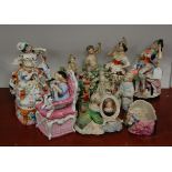 An early 19th century bocage figure of a lady in seated pose, together with various other 19th