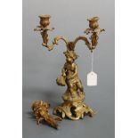 A late 19th century gilt metal three sconce table candlestick, the whole surmounted by a seated