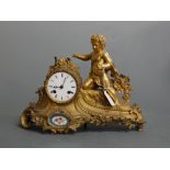 A late 19th century French gilt metal mantel clock, the circular enamel dial with Roman numerals