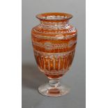 A large early 20th century Bohemian style amber overlaid and cut glass vase of baluster form, 28cm