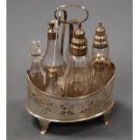 A George III silver 7 bottle cruet stand of pierced oval form, the bottles with canted corners and
