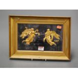 A framed gilt metal classical plaque, depicting winged angels with cherubs, 15 x 25cm