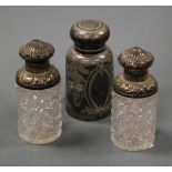 A pair of circa 1900 cut glass and silver topped dressing table bottles with stoppers, height