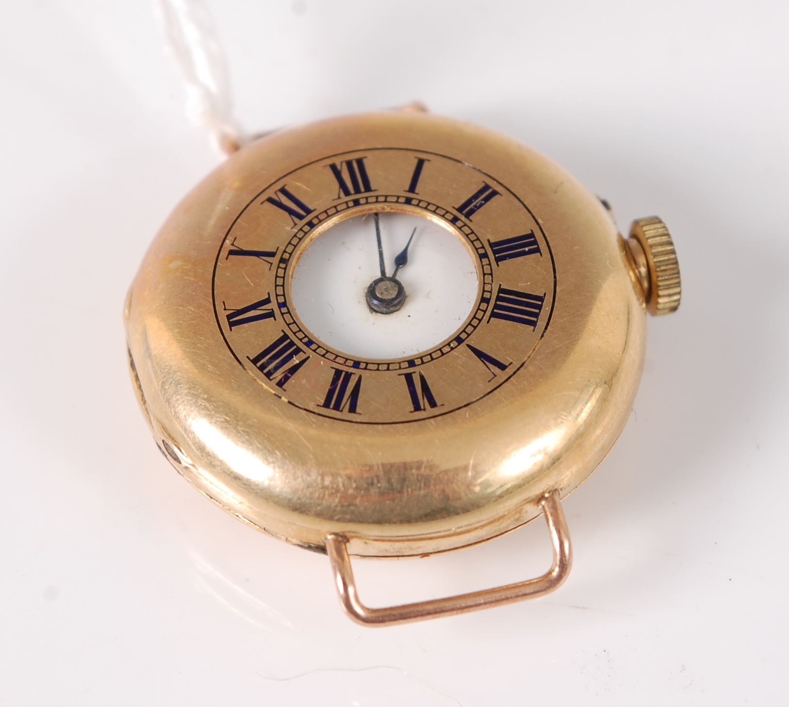 A lady's continental 18ct gold cased half hunter wristwatch, with enamel set monogram to back,