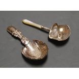 A 19th century silver caddy spoon, having a shield shaped bowl with engraved decoration and shell