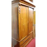 A Victorian walnut wardrobe, the raised twin upper doors enclosing hanging rail over twin long lower