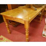 A modern pine round cornered farmhouse style kitchen table on turned supports, length 182cm