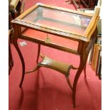 An early 20th century walnut glazed and hinged top bijouterie table, raised on cabriole supports