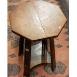 An Arts & Crafts oak octagonal topped two tier occasional table, raised on slightly tapering pierced