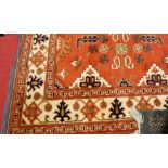 A Turkman woollen red ground rug having a floral stylised ground, 235 x 173cm