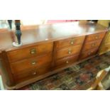 A late Victorian walnut round cornered long bank of drawers, the nine drawers comprised of three