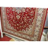 A machine-woven Persian woollen red ground kashan carpet, 300 x 200cm