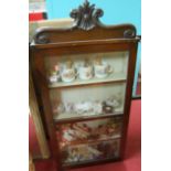 An early Victorian mahogany single door glazed hanging collectors cabinet, with sundry contents to