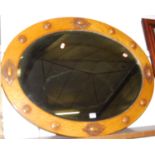 A moulded oak and bevelled oval wall mirror, w.91cm