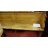 A Victorian scrumble finished long waiting room bench, reputedly from the Justice Room in the