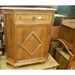 A contemporary oak credence shaped single door side cupboard, having single upper drawer, w.71cm;