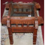 A Middle Eastern relief carved hardwood and glass inset square low occasional table