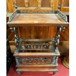 A mid-Victorian rosewood fret carved canterbury whatnot, having single lower blind drawer, on turned
