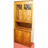 A reproduction mahogany narrow bookcase cupboard, having twin astragal glazed upper doors, w.84cm