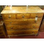 A Victorian stained pine round cornered chest of three short over three long drawers, on turned