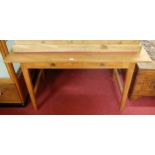 A teak and rexine inset two drawer writing table, on slightly square tapering supports, width 120cm