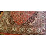 A Persian style machine woven cream ground rug