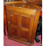 An early 20th century oak ledgeback low single door corner cupboard, w.80cm