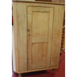 A reclaimed scrubbed pine single door freestanding corner cupboard, raised on turned supports, h.