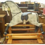 A contemporary dapple-grey childs rocking horse, of good size, having a leather saddle, raised on
