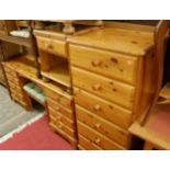 A suite of contemporary Ducal pine bedroom furniture, to include; kneehole long mirrorback