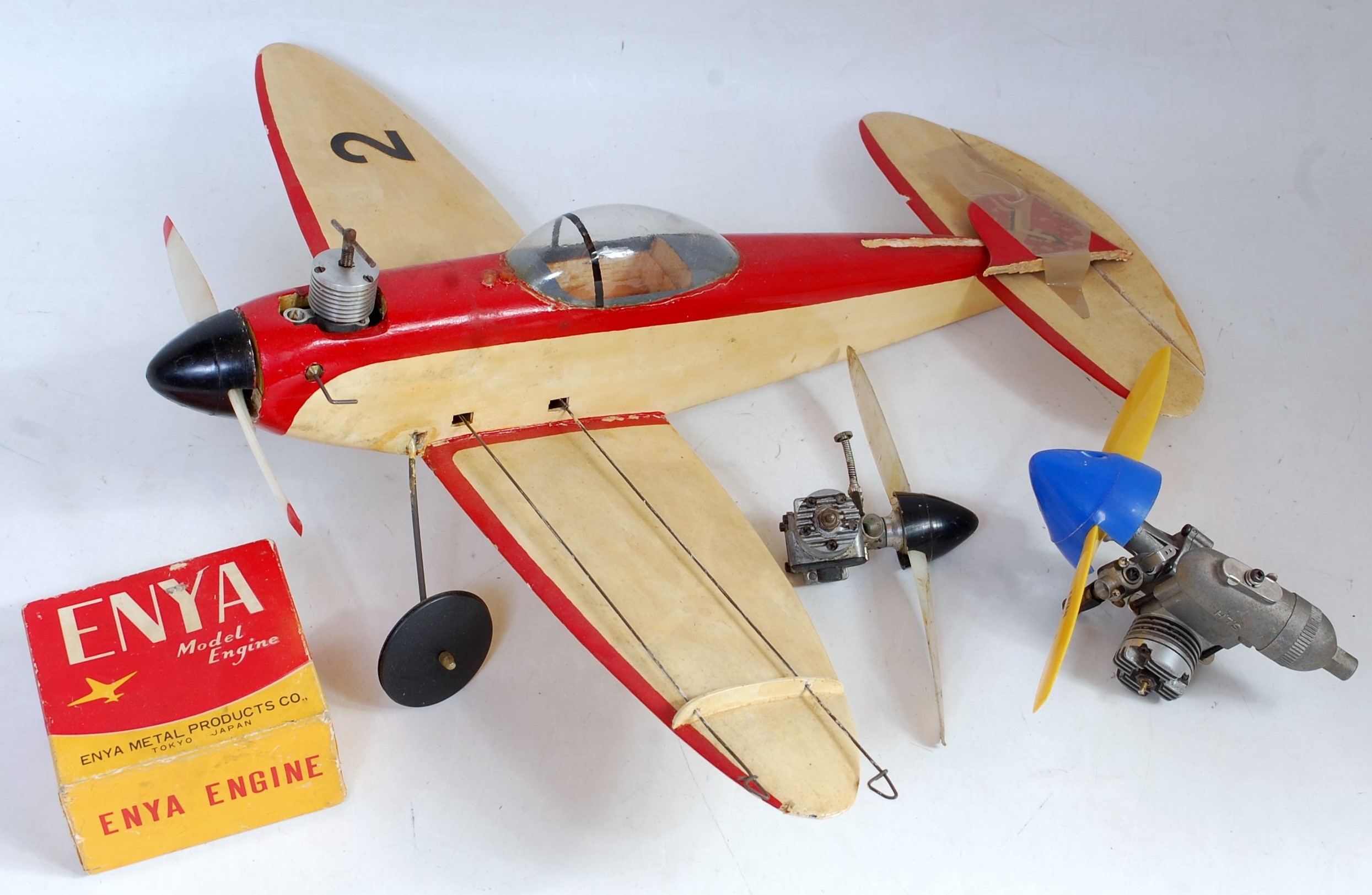 A balsa wood and plastic kit built petrol powered radio controlled aircraft, sold with a quantity of
