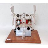 An unusual home made polished metal stationary hot air engine comprising of polished metal A frame