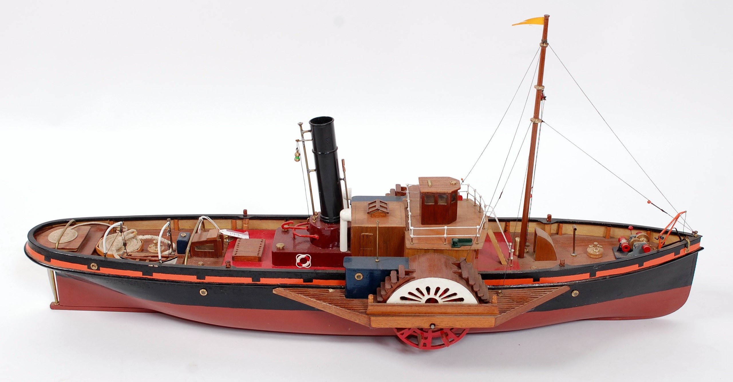 A kit built balsa wood and wooden model of a twin paddle steam boat comprising of red, black and