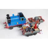 Three 2-rail items: small 0-4-0 Thomas The Tank engine, unidentified commercial make, appears to