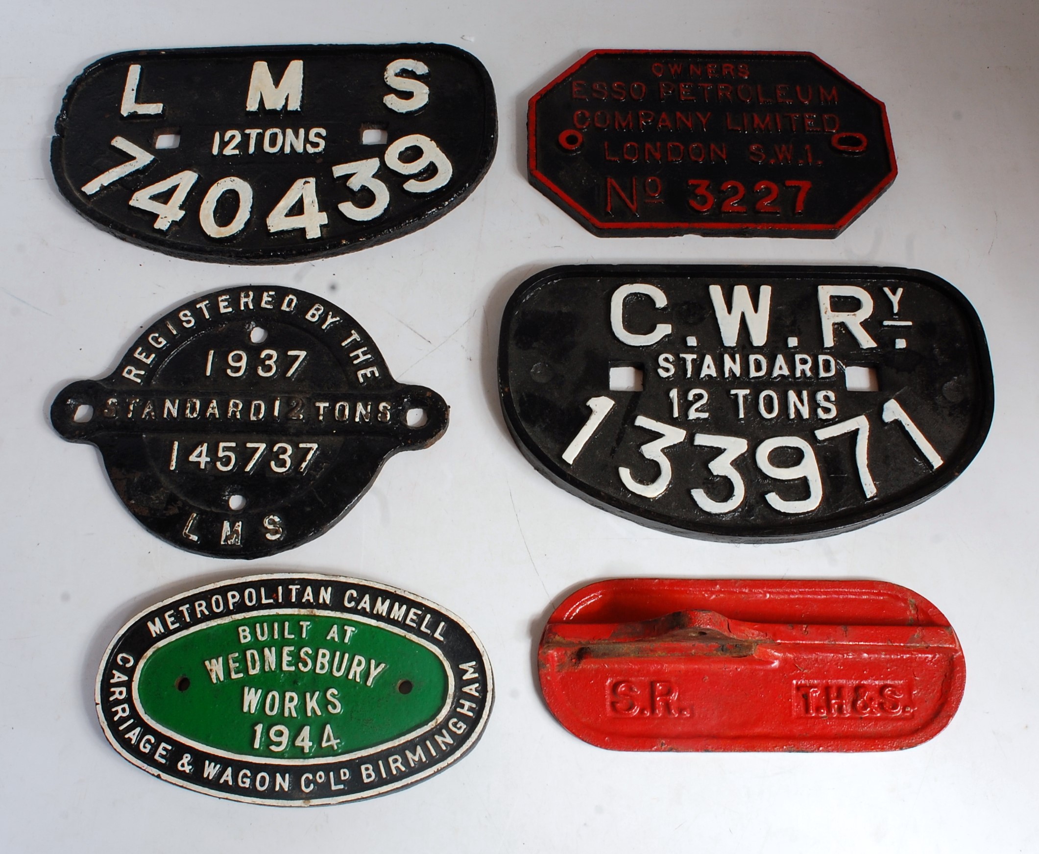 Six various cast iron railway wagon plates and signage to include LMS 12 tons 740439 wagon plate,