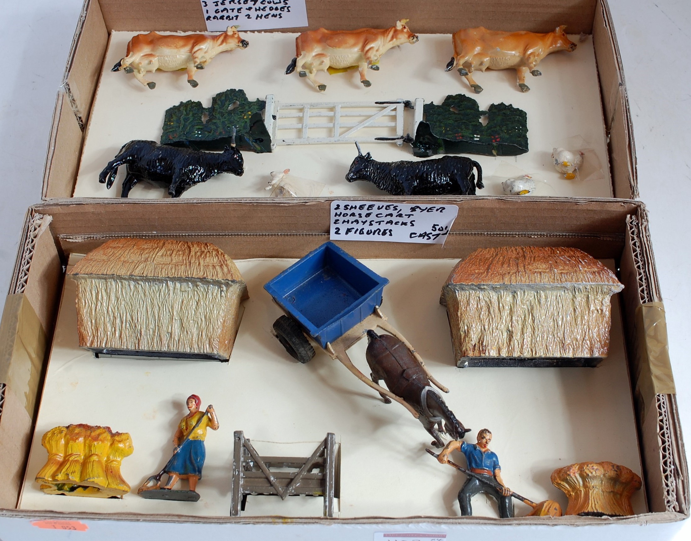 Four various boxes containing a quantity of lead and hollow cast, mainly farming figures, mixed