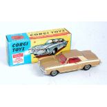 A Corgi Toys No. 245 Buick Riviera comprising gold body with red interior and wire work cast hubs,