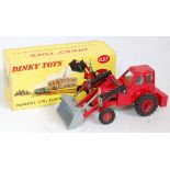 A Dinky Toys No. 437 Muir Hill two wheel loader comprising of red body with grey bucket, and dark