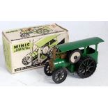 A Triang Minic tinplate and clockwork model of a traction engine comprising of green body with black