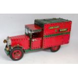 A home-made Meccano four wheel delivery lorry comprising of various red, green and base metal
