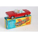 A Corgi Toys No. 246 Chrysler Imperial saloon comprising of red body with light blue interior,