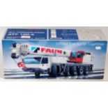 A Conrad No. 2096 1/50 scale model of a Tadano faun all-terrain crane 80th 100-50 appears as