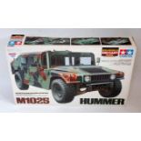 A Tamiya 1:20 scale semi assembled diecast model kit for an M1025 Hummer, all housed in the original