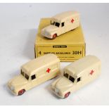 A Dinky Toys No. 30H Daimler Ambulance trade box containing three various Daimler ambulances in